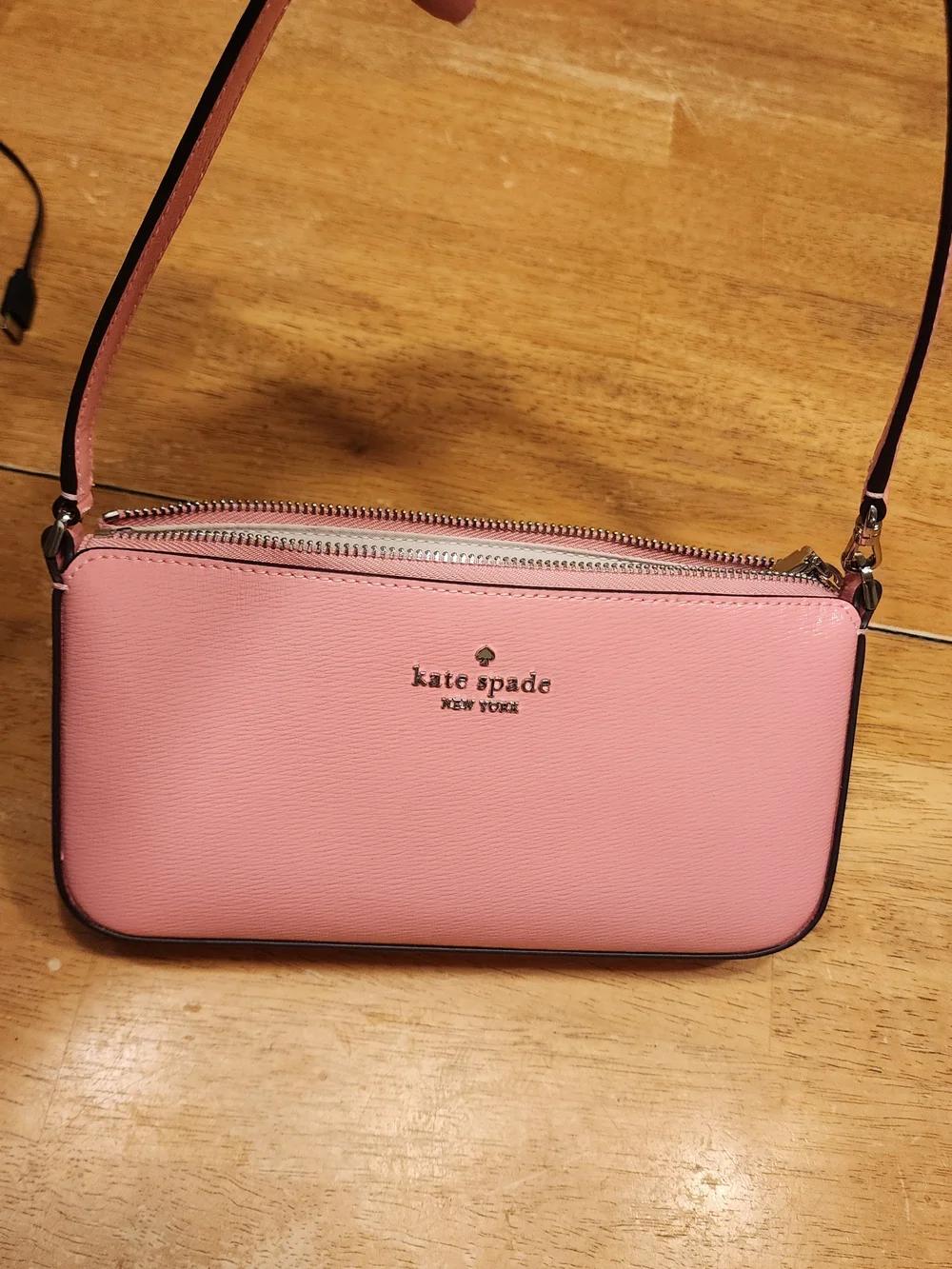 Kate Spade New York Gemini Convertible Wristlet in a pink color